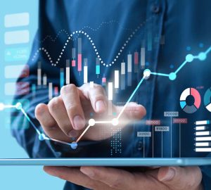 man on tablet with graphs and numbers floating above the tablet